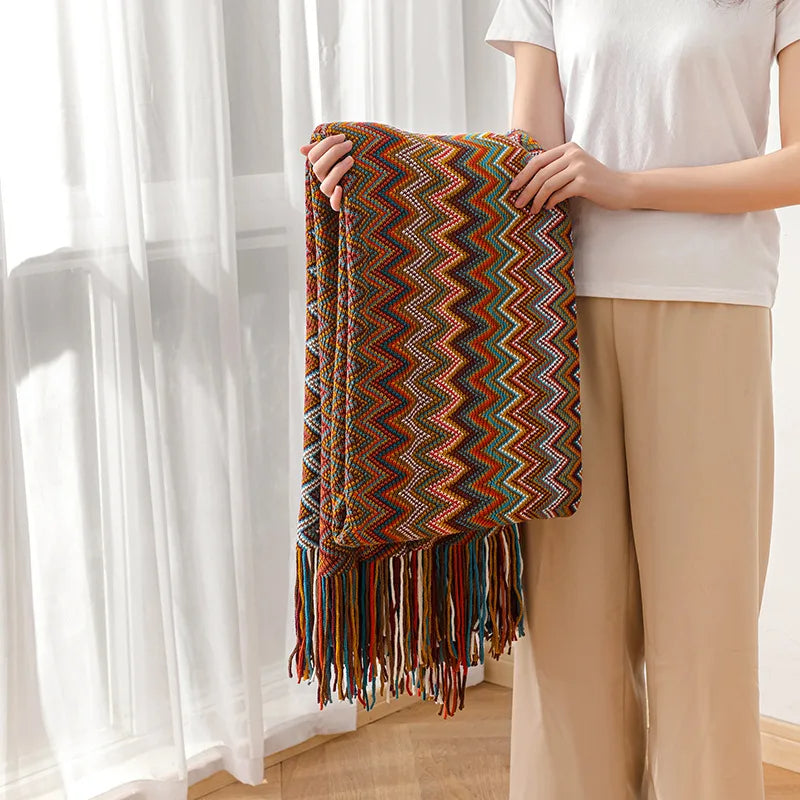 Living room boho decor: striped tassel throw blanket, cozy and aesthetically pleasing.
