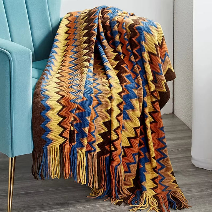 Soft boho throw blanket with striped pattern & decorative tassels, ideal for a cozy living room.
