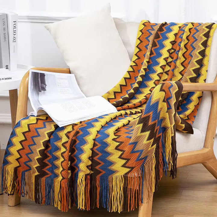 Breathable striped throw blanket, boho style with tassel fringe, perfect home decor accent.