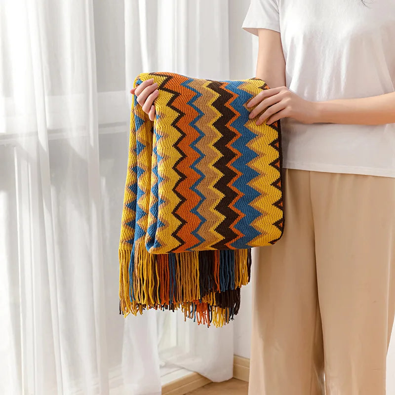 Decorative boho throw with stripes and tassels, adding a cozy and soft touch to any room.
