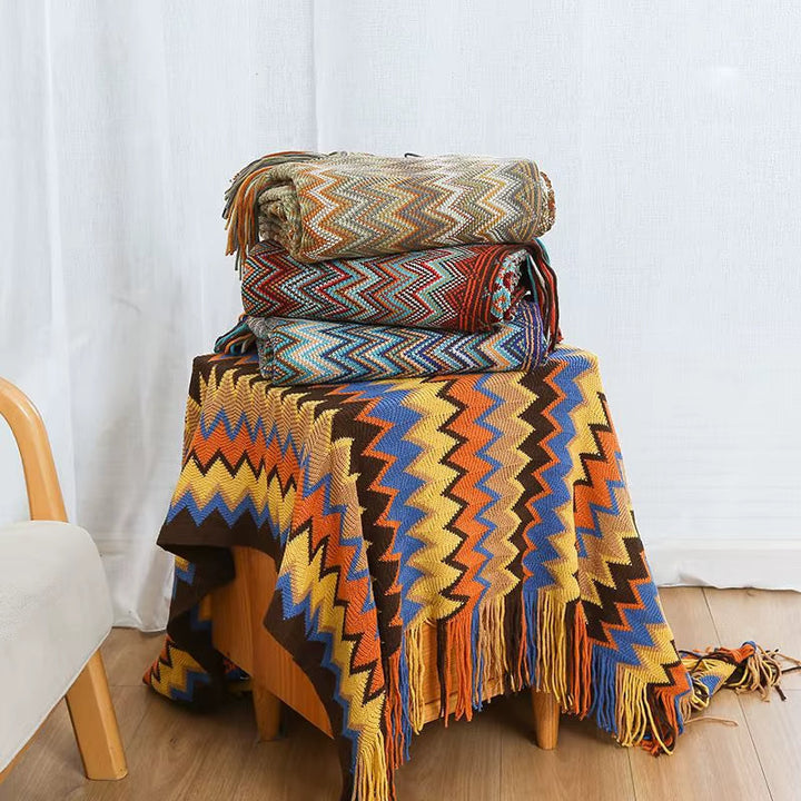 Boho-chic striped throw blanket, soft & cozy with charming tassels for elegant home decor.