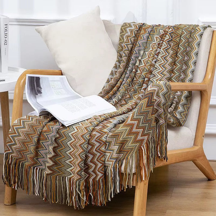 Home decor essential: soft striped boho throw blanket with decorative tassels for a cozy feel.
