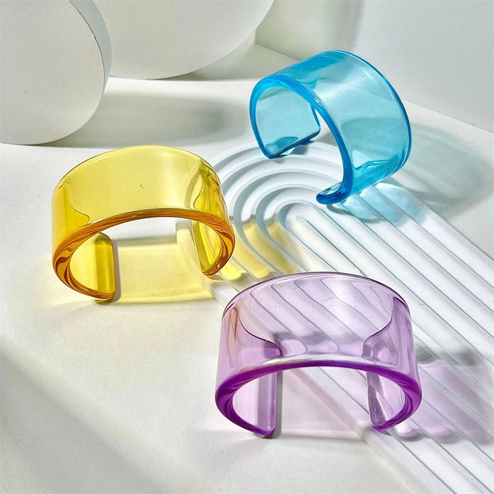 Stylish women's bold acrylic cuff bracelet, chunky statement accessory with glossy sheen.