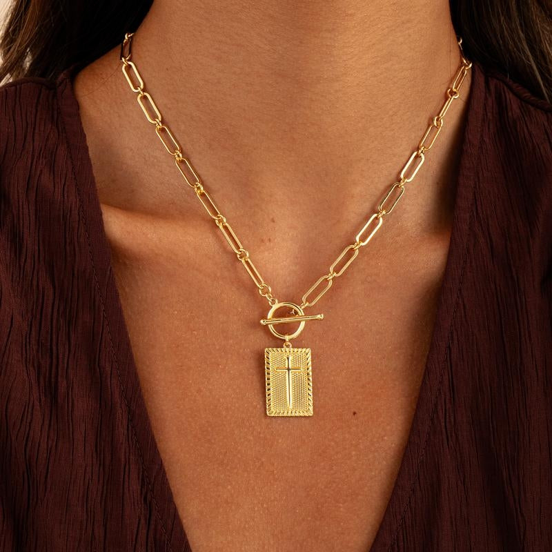 Bold gold cross pendant necklace on a trendy paperclip chain. Unisex statement jewelry for men & women.