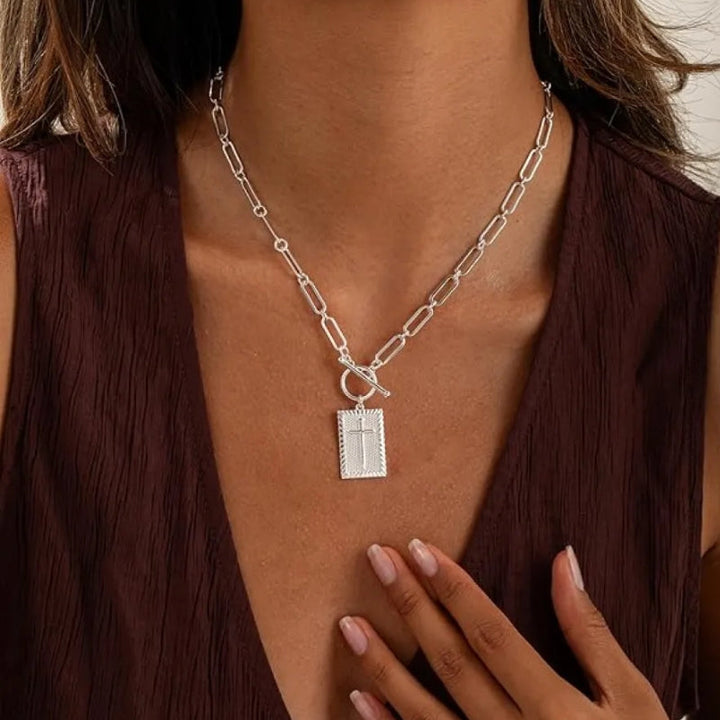 Gold-tone statement cross pendant necklace. Bold design on a stylish paperclip chain for unisex wear.