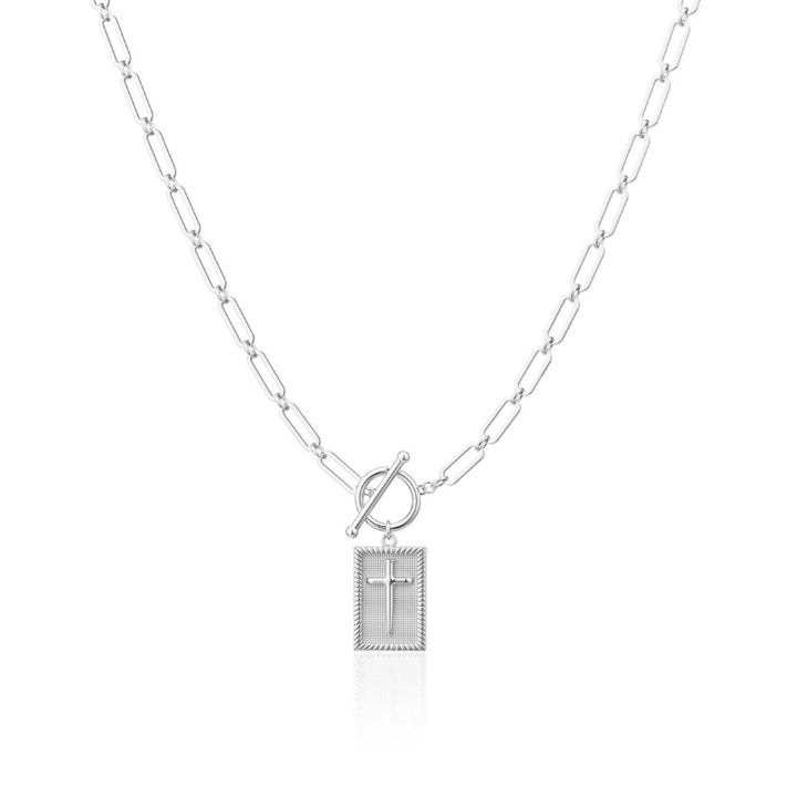 Edgy silver cross pendant necklace featuring a substantial paperclip chain. Versatile unisex accessory.