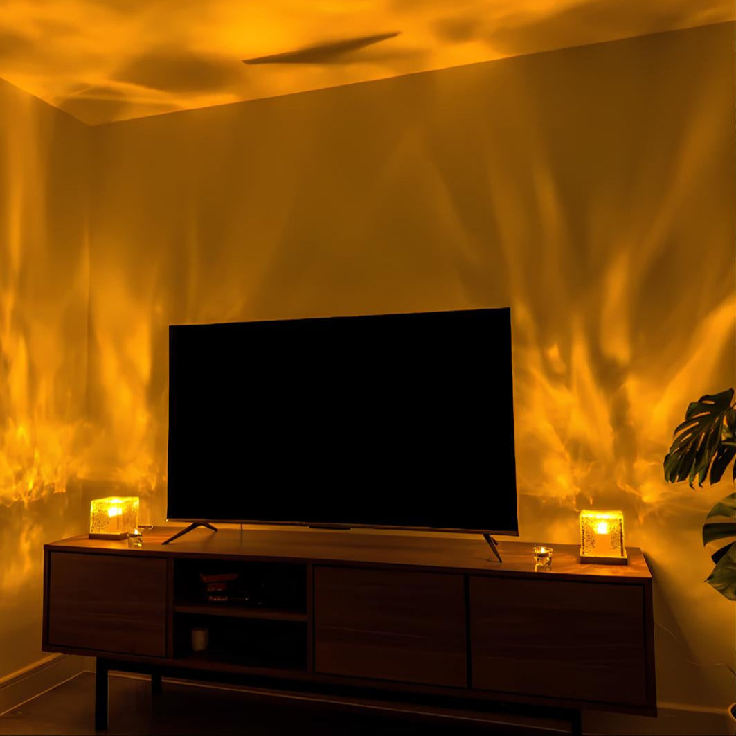 Compact Borealis Cube light, casting colorful northern lights onto a wall in a dark room