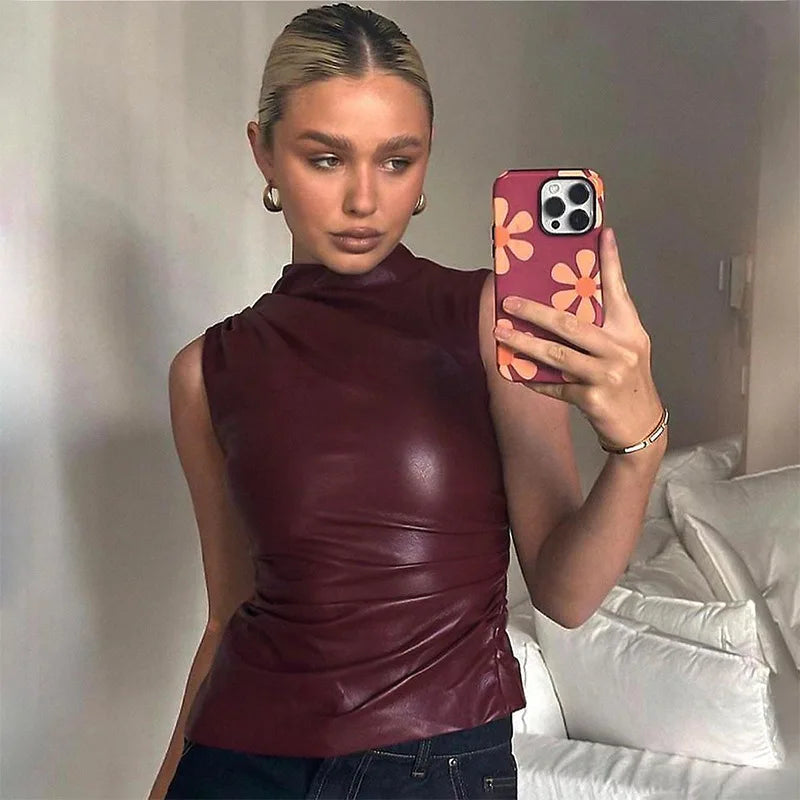 Close-up of a women's burgundy top, showcasing its tailored detail