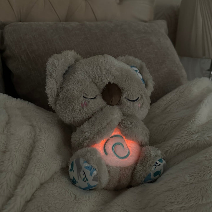 Soft plush koala breathing toy, a sleep assistant and meditation aid promoting peaceful sleep.