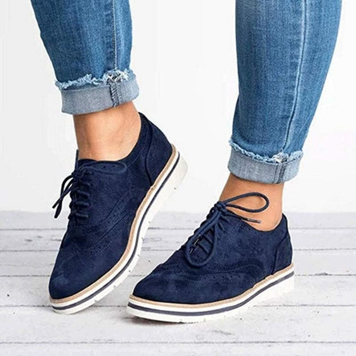 Comfortable women's fashion suede Derby shoes by Carisse with timeless brogue design and flat sole.