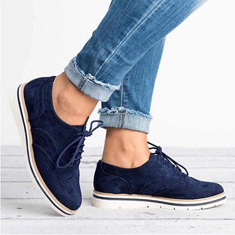Close-up of Carisse women's suede Derby shoe showcasing intricate brogue details and quality craftsmanship.