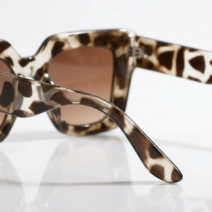 White Carlotta square sunglasses for women. A chic accessory, offering stylish eye protection & fashion.
