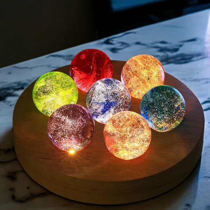Celestial Galaxy Crystal Orb on a wooden table, creating a soft ambient light, home decor