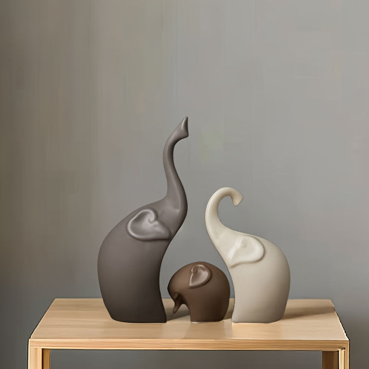 Stylish ceramic elephant family figurines, a modern trio for shelves, mantels, or office decor.
