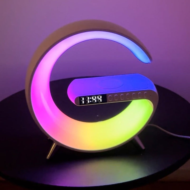 Desk accessory with wireless charging, Bluetooth speaker, LED mood lighting, and alarm clock
