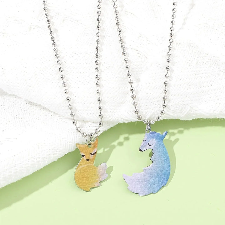 Elegant silver-tone fox and wolf couple necklace. Unique animal jewelry showcasing a special bond.
