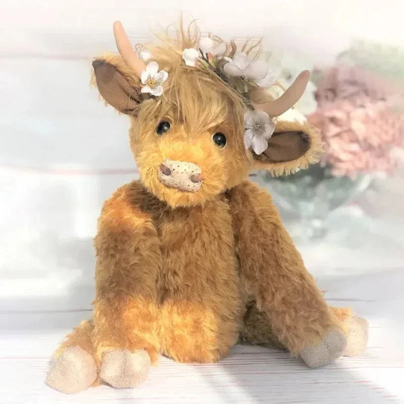 Handcrafted Highland Cow plush with an adorable floral crown. A soft farm animal toy, perfect home accent or gift.