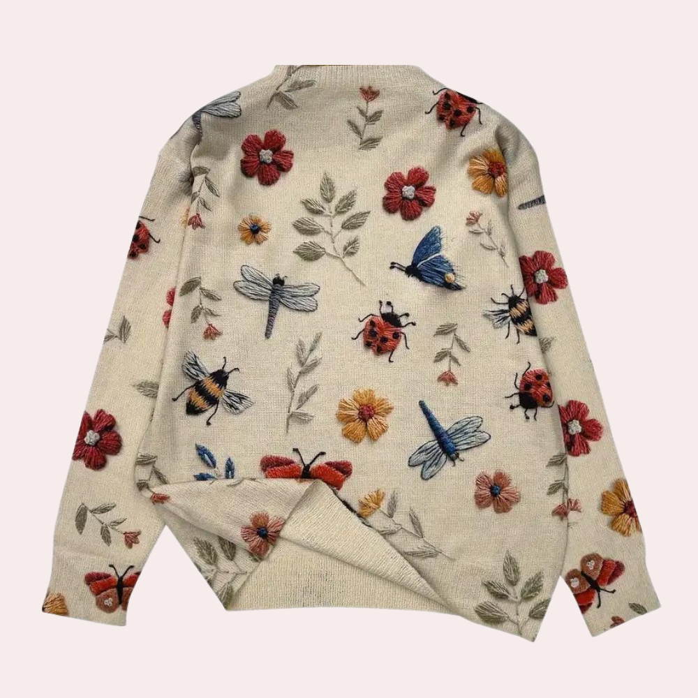 Elegant white women's sweater with vibrant floral print, comfortable and stylish for spring.