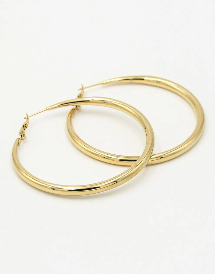 Stylish 60mm gold-plated hoop earrings for women. Chic statement jewelry, perfect for a fashionable look.