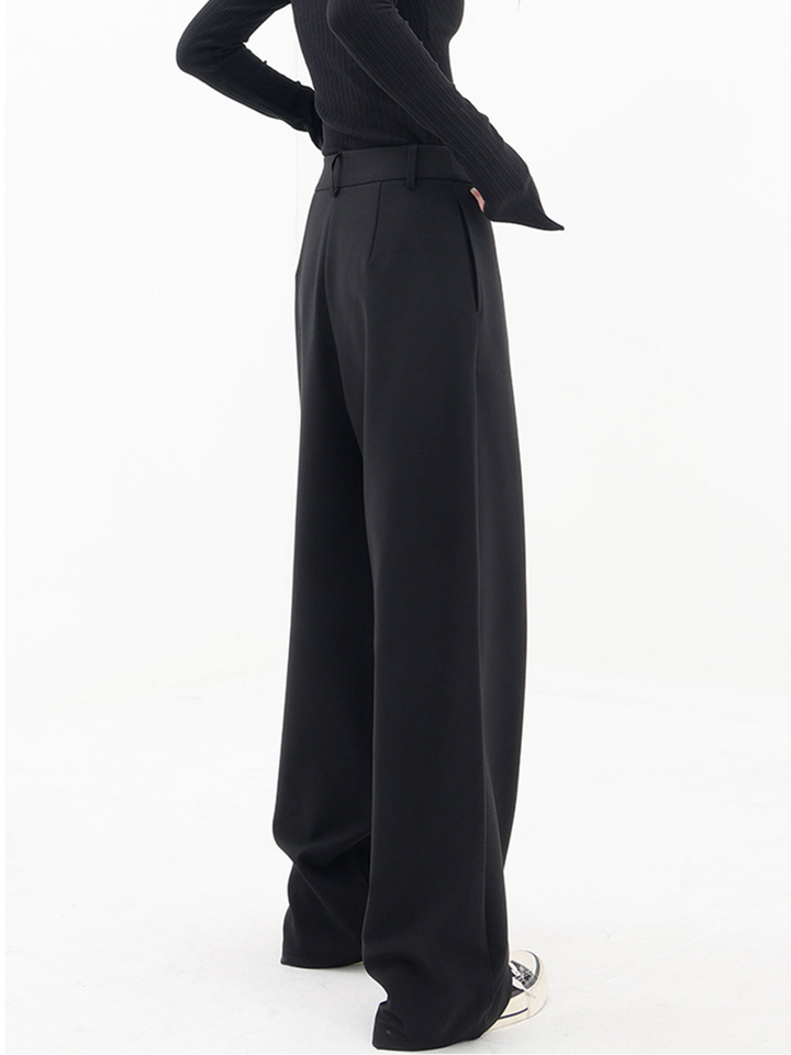 Women's chic asymmetrical baggy trousers, modern style, low waist. Comfortable & elegant fashion bottoms.