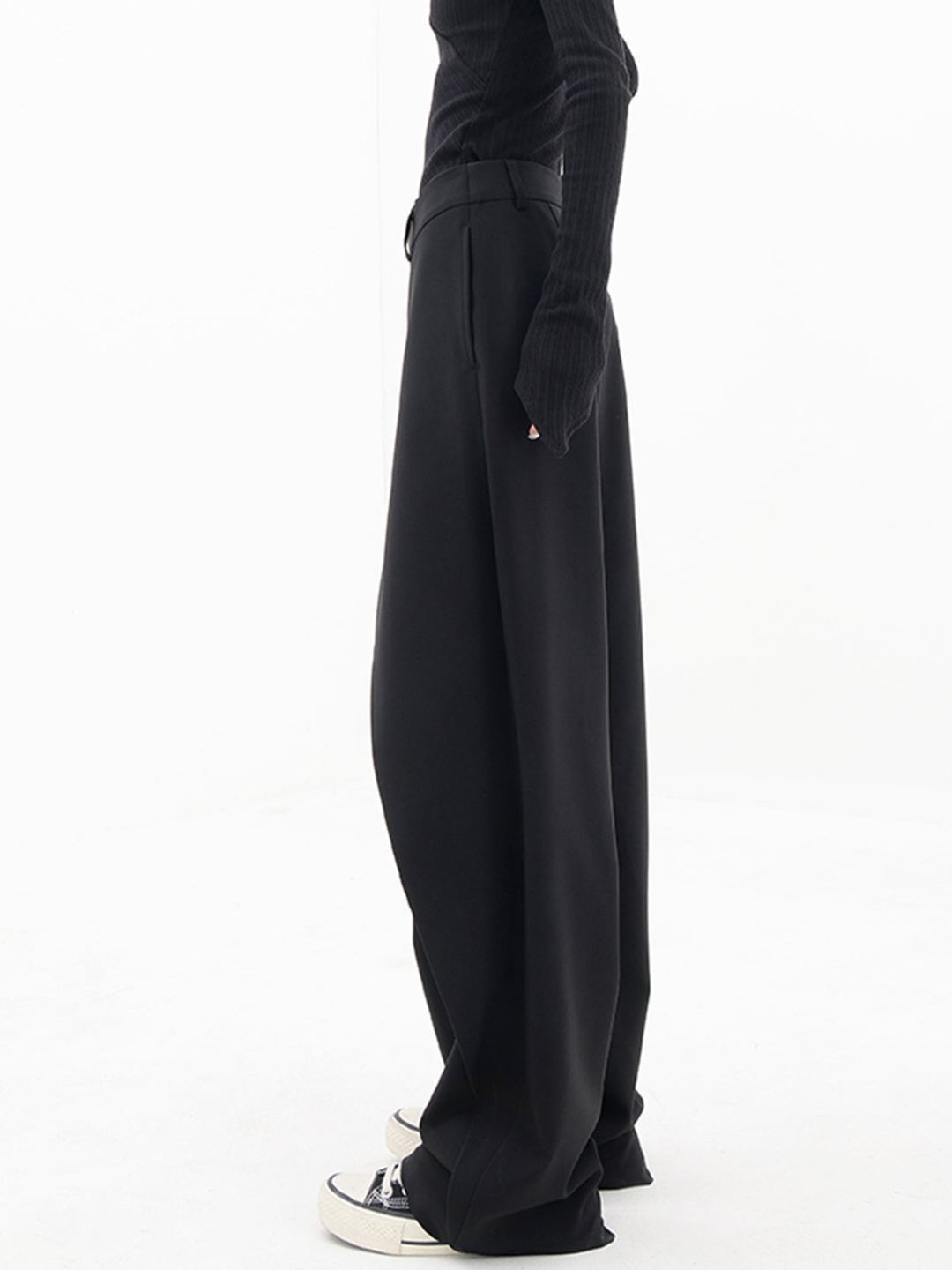 Stylish low-waist baggy women's pants, modern asymmetrical design. Comfortable and versatile contemporary apparel.