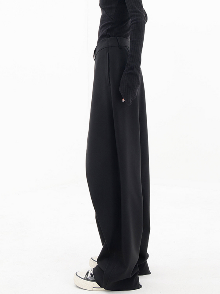 Stylish low-waist baggy women's pants, modern asymmetrical design. Comfortable and versatile contemporary apparel.