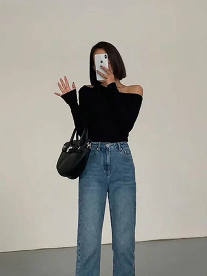 Women's stretch long sleeve off-shoulder top in black, offering effortless chic style & comfort.