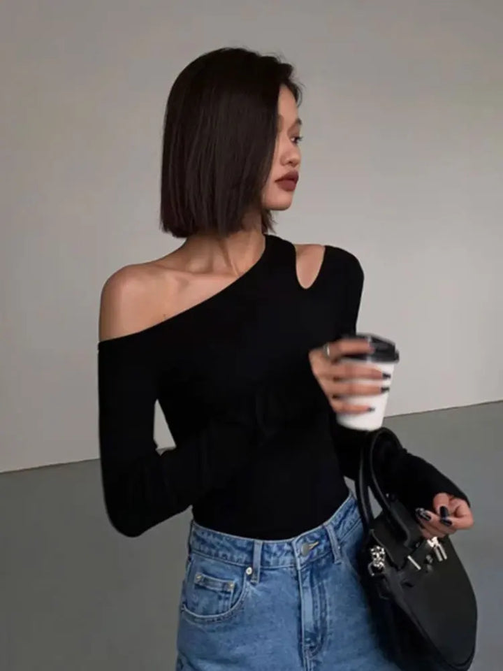 Elegant black long sleeve off-shoulder top for women, blending chic fashion with versatile wear.