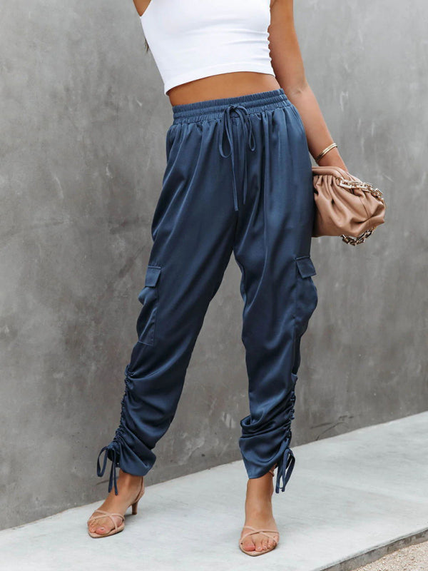 Stylish blue satin cargo trousers for women, combining comfort with a modern, sophisticated aesthetic.
