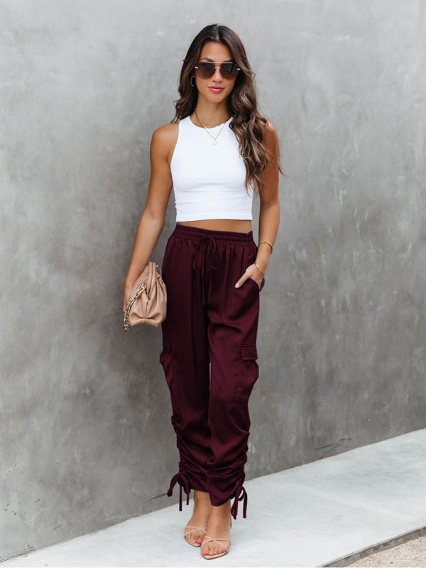 Black satin cargo trousers for women, a comfortable and chic bottom for any fashion-forward ensemble.