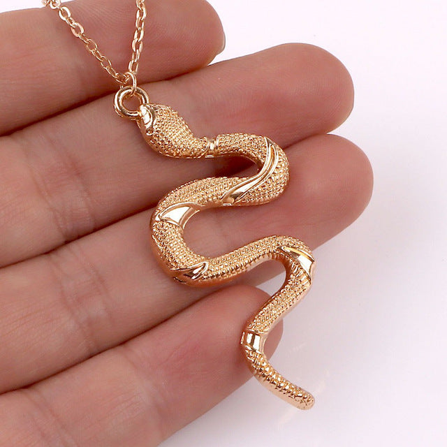 Gold-tone crystal snake earrings, chic women's jewelry, a stunning statement piece.