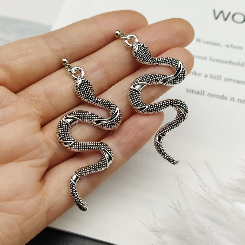 Women's elegant crystal serpent earrings, a fashionable snake jewelry accessory.
