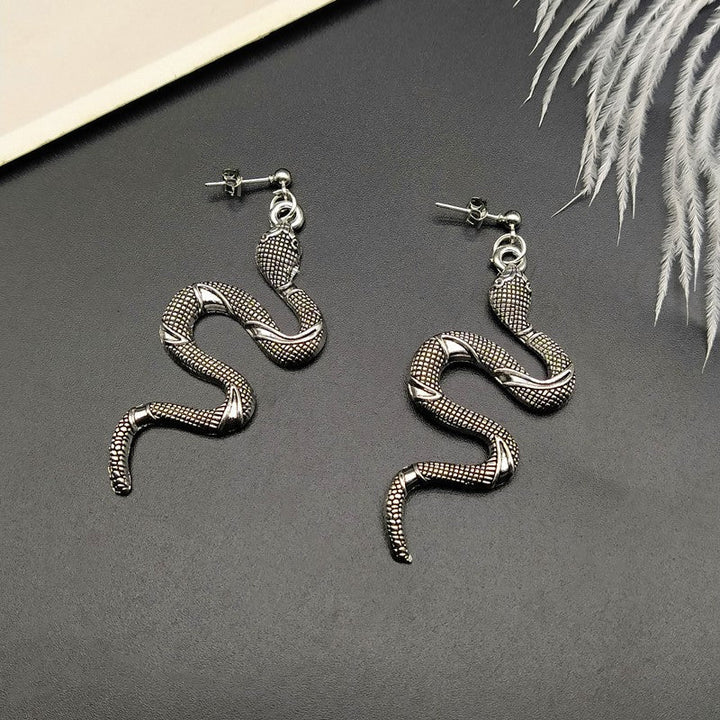 Modern crystal snake earrings, an elegant women's accessory, part of chic serpent jewelry.