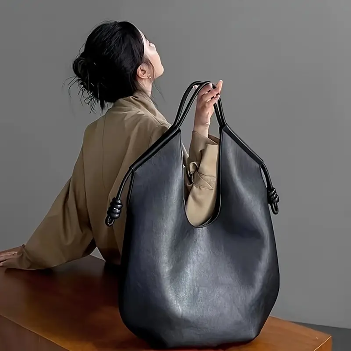 Obsidian black oversized vegan leather tote bag for women, a stylish and spacious carryall.