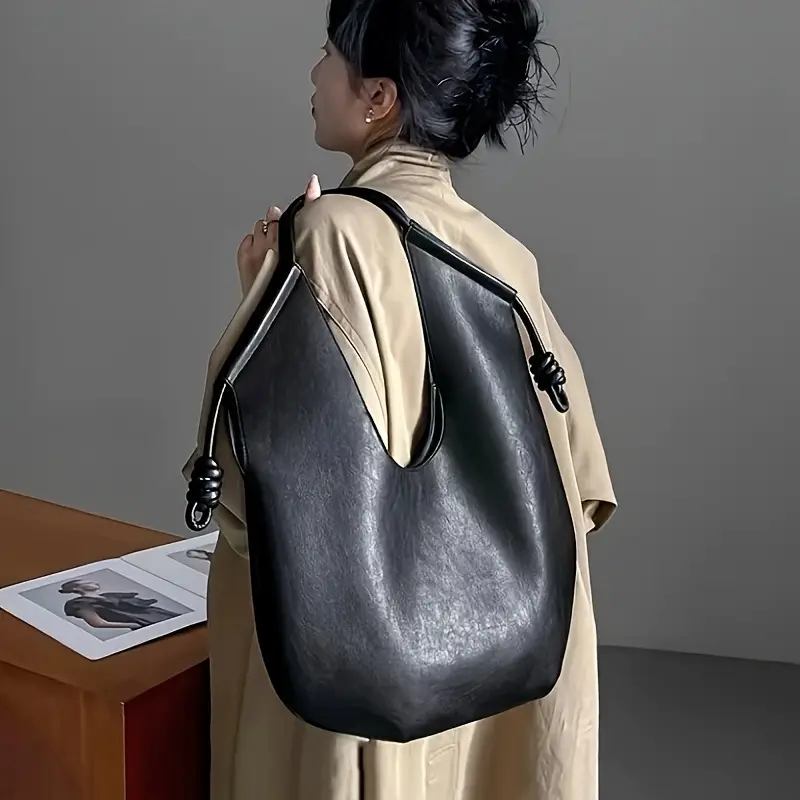 Spacious women's vegan leather carryall tote bag, ideal for everyday use with a chic design.