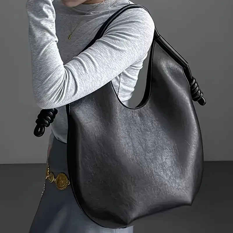 Textured vegan leather on a chic oversized women's tote bag, highlighting quality and style.