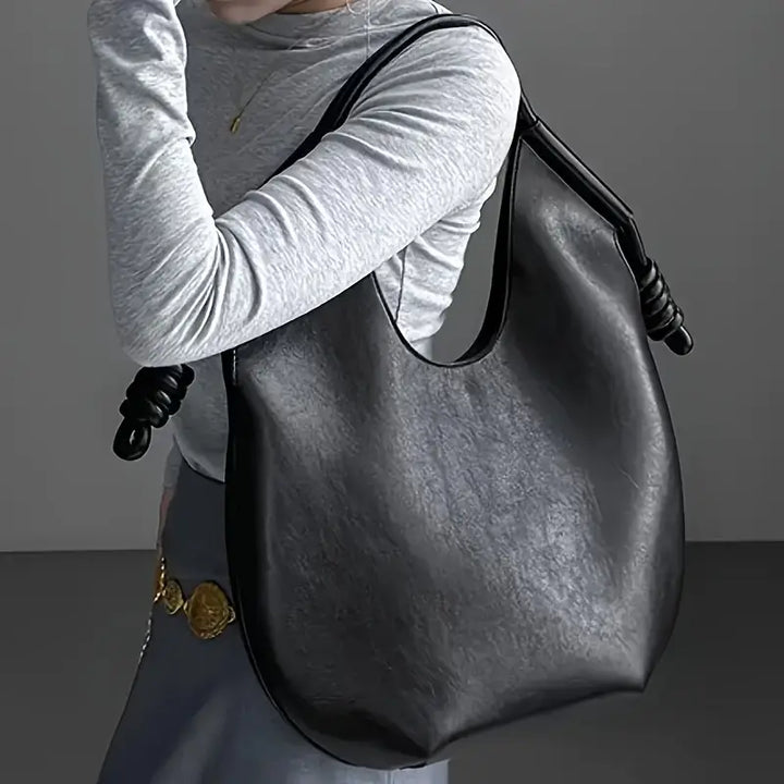 Textured vegan leather on a chic oversized women's tote bag, highlighting quality and style.