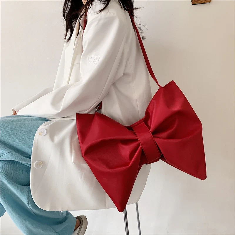 Chic oversized women's tote bag with a playful bow design, a fashion accessory for everyday style.