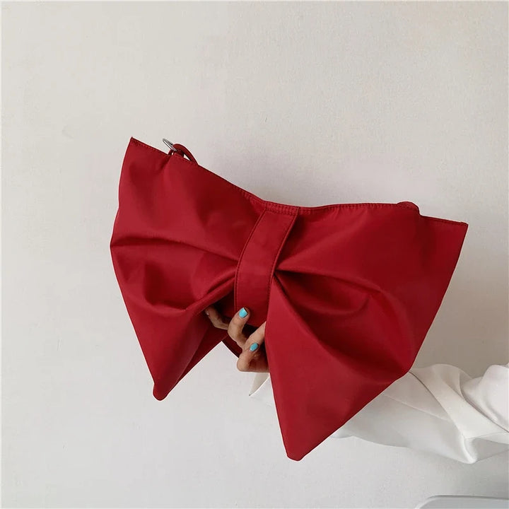 Stylish canvas oversized tote bag for women, featuring a large decorative bow and spacious interior.