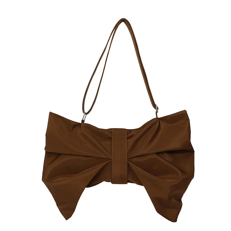 Fashionable women's oversized bow tote bag, a chic statement accessory adding playfulness to any outfit.