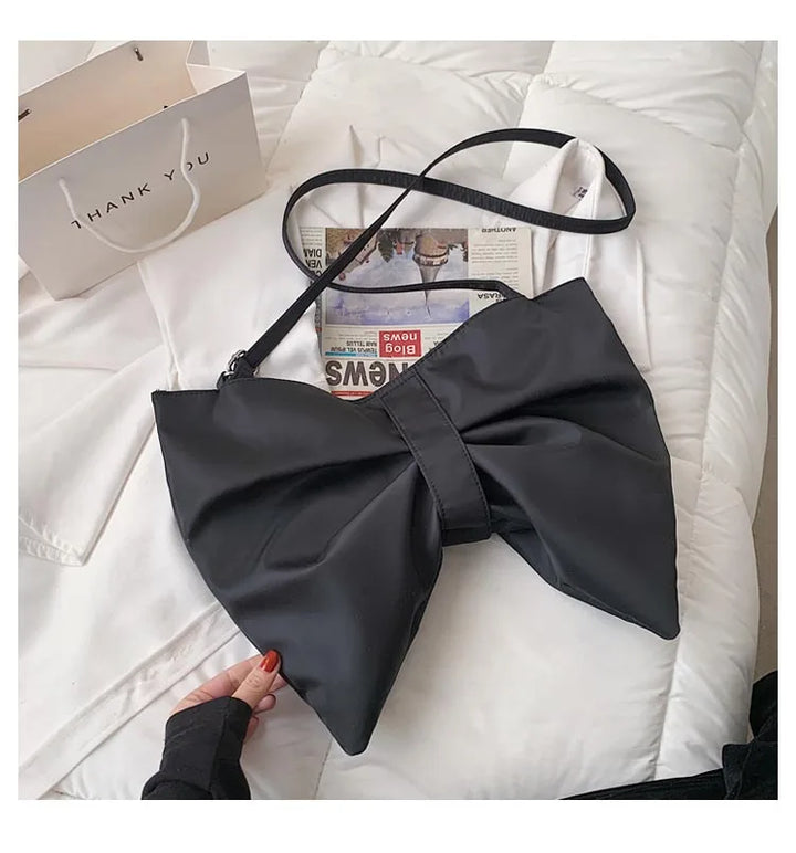 Durable canvas oversized tote bag for women, featuring a chic bow, perfect as a stylish and roomy shoulder bag.