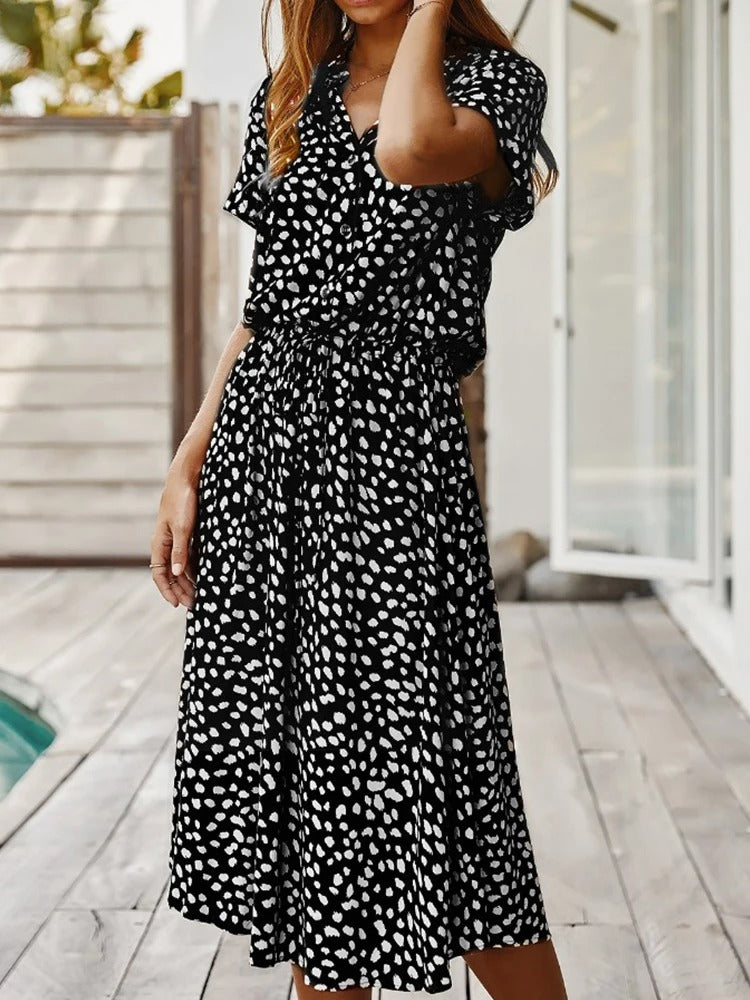 Angled view of women's chic printed summer midi dress, short sleeve, comfortable and fashionable.