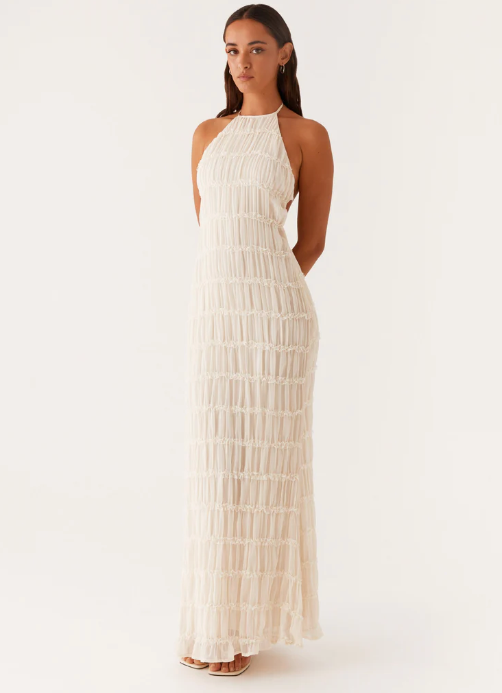 Chic textured halter maxi dress, perfect for wedding guests. Elegant women's evening gown with open back.
