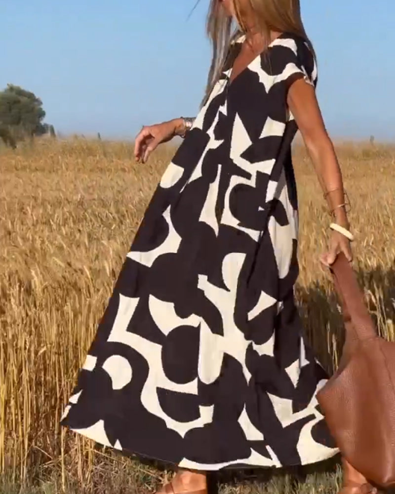 Vibrant abstract print women's summer dress, flowy & relaxed, ideal for casual and vacation style.