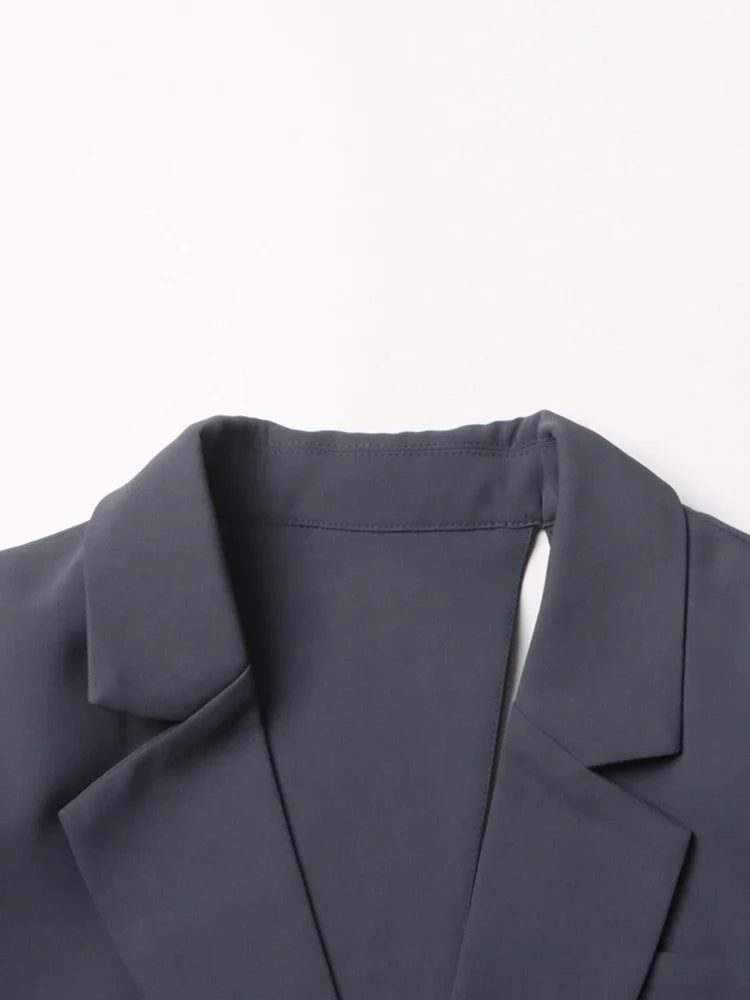 Stylish gray asymmetric cutout jacket, a fashion-forward blazer for modern outerwear and elegant looks.