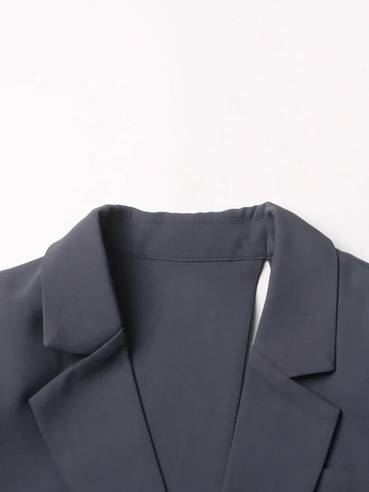 Stylish gray asymmetric cutout jacket, a fashion-forward blazer for modern outerwear and elegant looks.