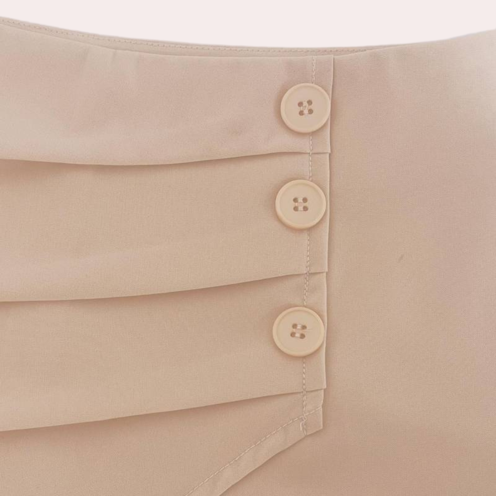 Fashionable women's asymmetric shorts with unique decorative buttons, ideal summer casual wear.