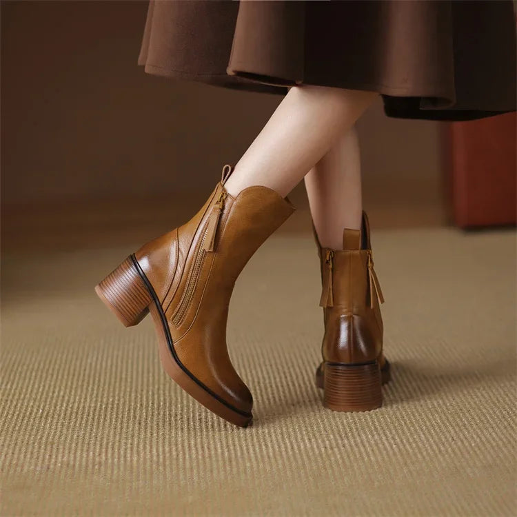 Black women's ankle boots: fashion footwear with a chic block heel, side zip, & comfortable design for daily wear.