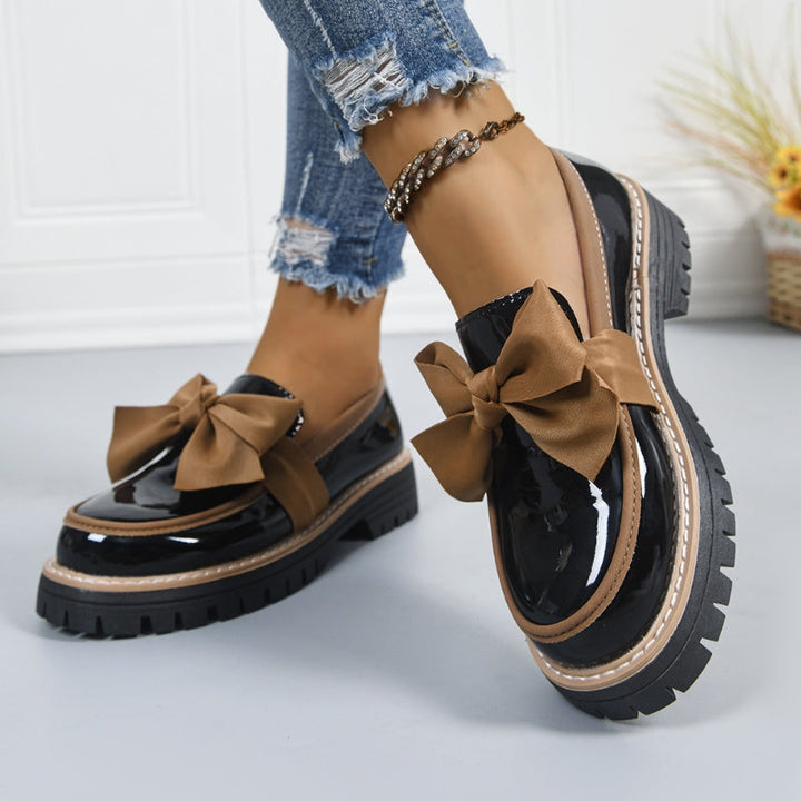 Stylish black platform loafers for women. Elegant bowknot detail, comfortable slip-ons for chic casual outfits.