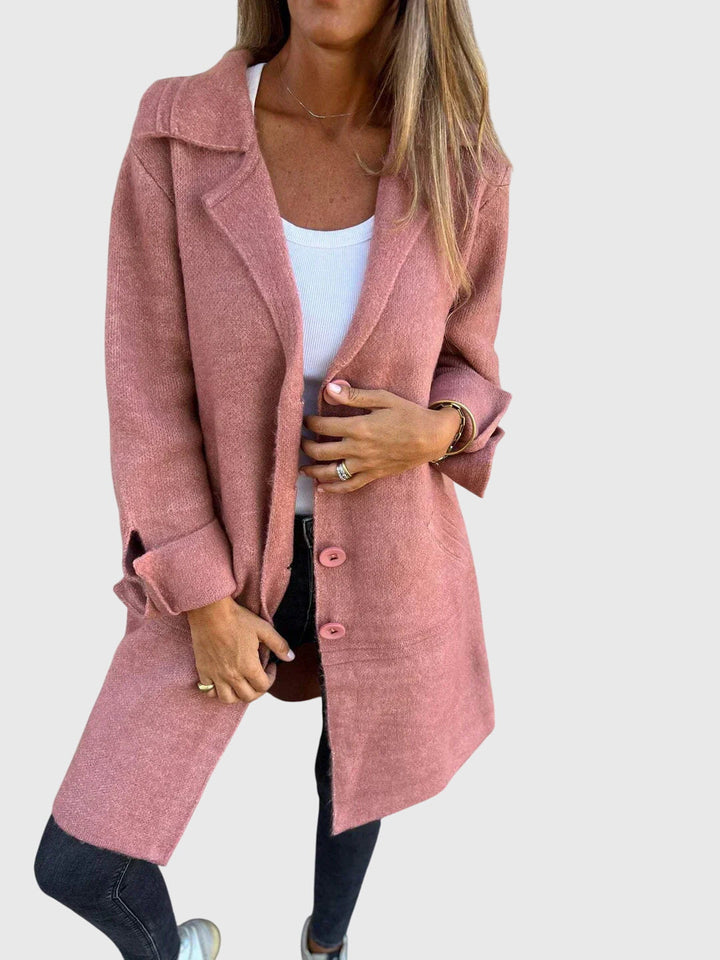 Tailored women's blazer with button accents, showcasing a modern, slim silhouette for business & smart casual.
